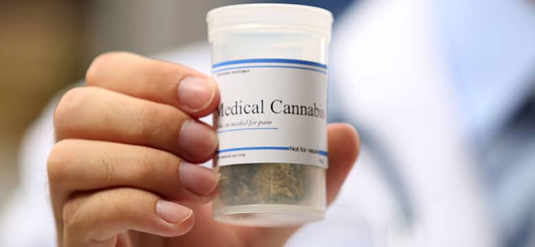 Man holding container of medical cannabis