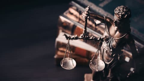 Gavel and scales in front of books