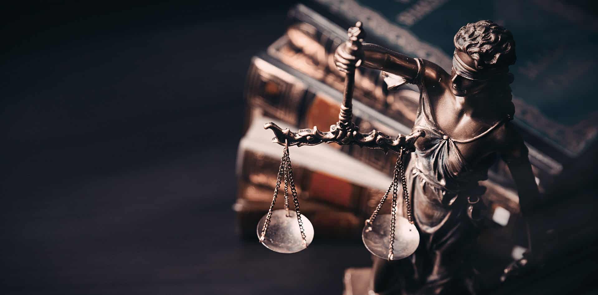 Gavel and scales in front of books