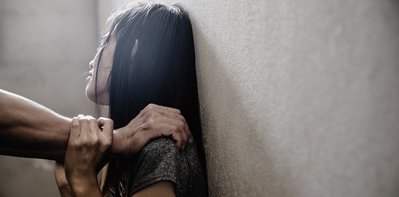 Man pinning woman to wall voilently