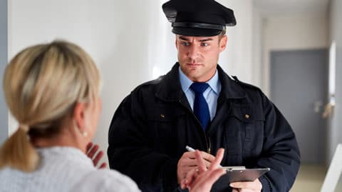 Police officer taking a statement from woman