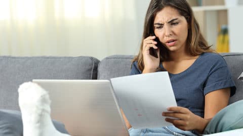 Woman with broken leg on phone