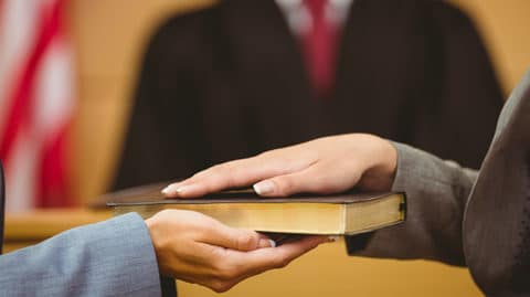 Witness swearing on bible