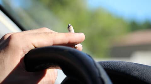 Car driver smoking marijuana image