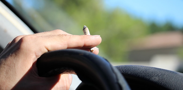 Car driver smoking marijuana image