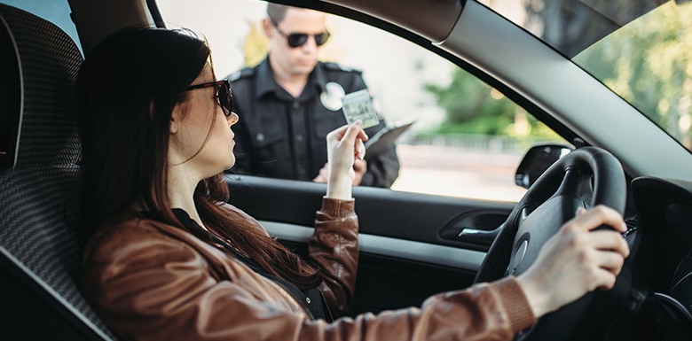 Driver handing over ID to police through window