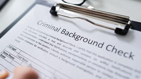 Using pen to fill out background check form