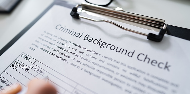 Using pen to fill out background check form