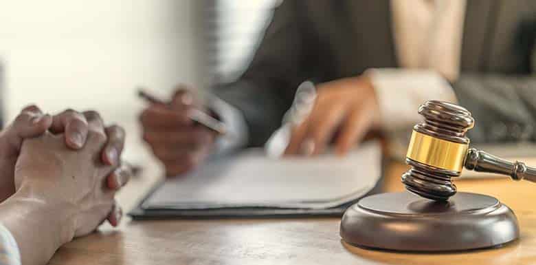 Two people talking on desk with gavel