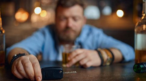 Drunk man contemplating car keys