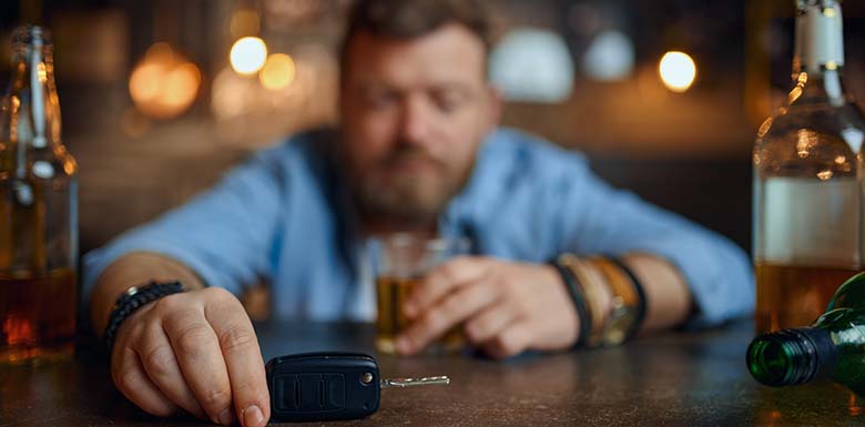 Drunk man contemplating car keys