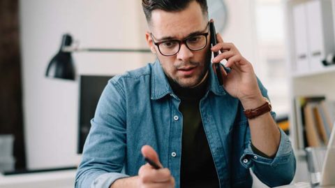 Man talking worriedly on the phone