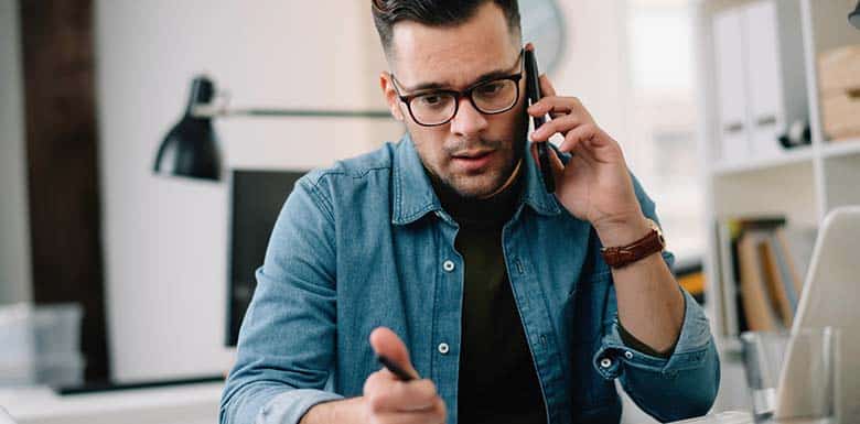 Man talking worriedly on the phone